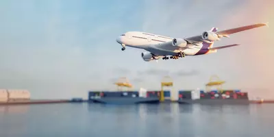 plane and boat flying over ocean