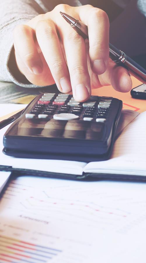 a man pays bills with a calculator