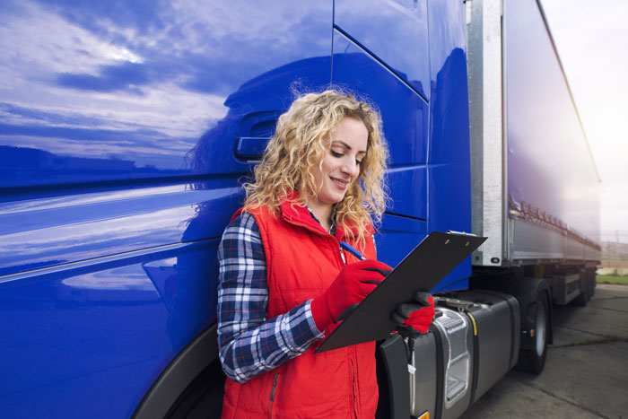 A worker surveying product with a clipboard. A paperwork trail is paramount for disputing OTIF claims.