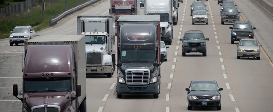 A picture of trucks on a highway. Teen truckers will soon be able to become truck drivers.