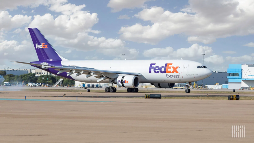 An image of a FedEx plane on a run way