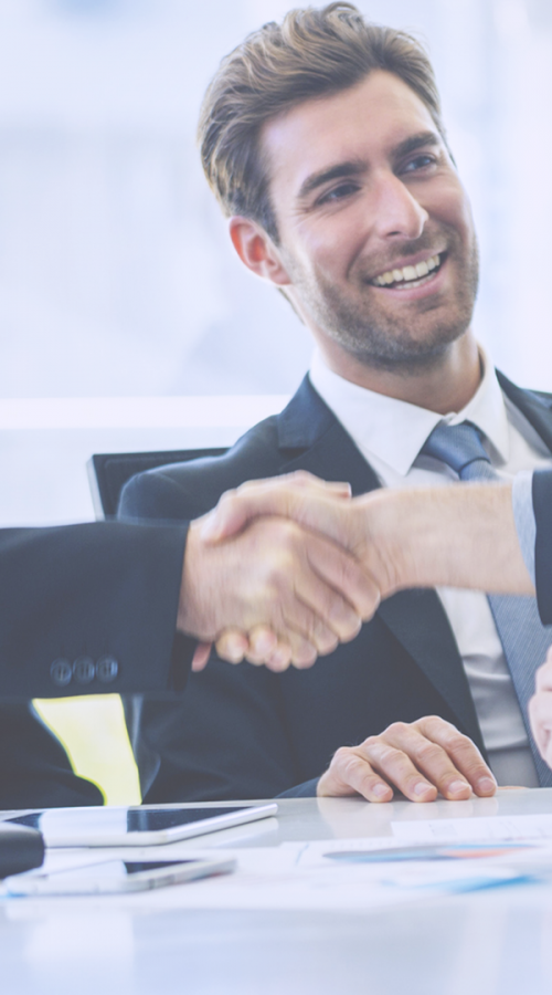 three men smile and shake hands