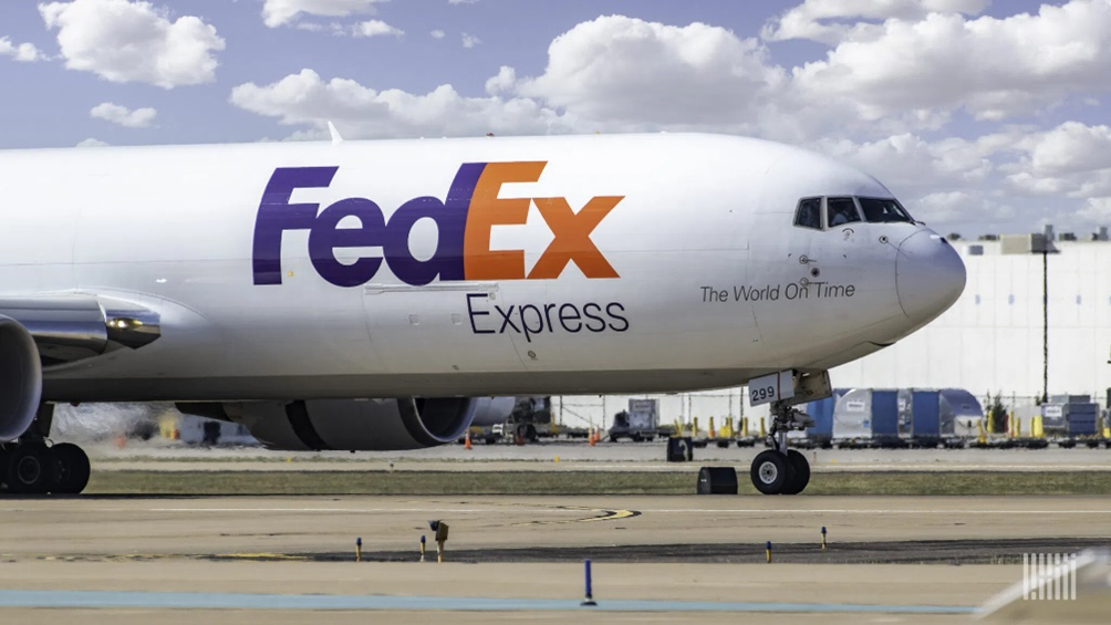 An image of a FedEx plane on a run way