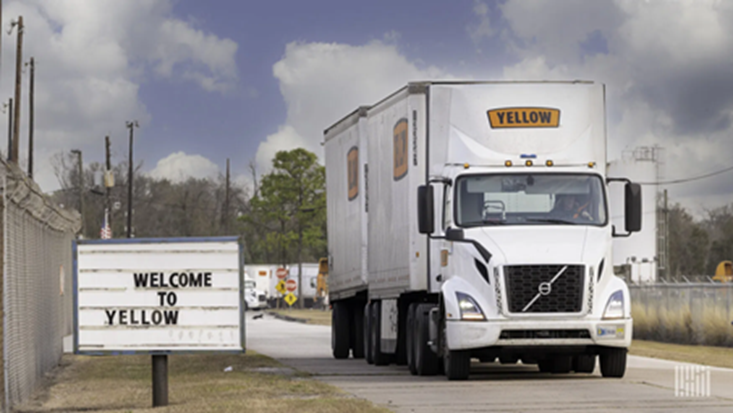 A picture of a Yellow Corp. truck next to a sign that says "Welcome to Yellow".